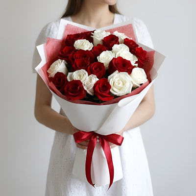 A woman is holding a bouquet with roses.